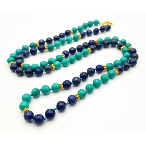 381 - A Lapis Lazuli and Turquoise Beaded Matinee Length Necklace. Gilded spacers and clasp. 88cm necklace... 