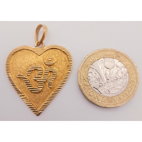 555 - An 18K Heart Pendant with Indian Hindu Design. 4cm x 3cm. 
5.9g