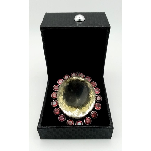 556 - A 157ct Well-Faceted Citrine Pendant with an 8.50ctw Rhodolite Halo. Set in 925 Silver. 6cm x 4.5cm.... 