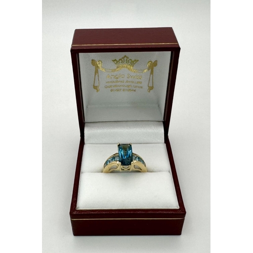 569 - A 9K Yellow Gold and London Blue Topaz Ring. Size M 1/2. 4.75g total weight. Comes with a presentati... 