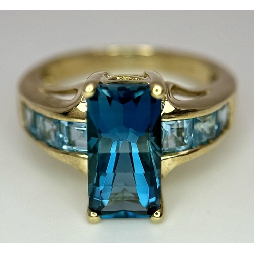 569 - A 9K Yellow Gold and London Blue Topaz Ring. Size M 1/2. 4.75g total weight. Comes with a presentati... 