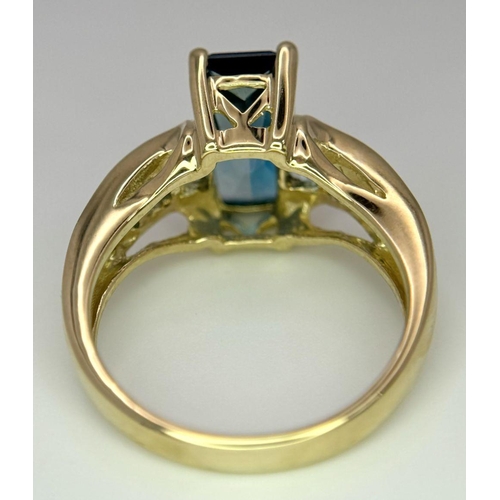 569 - A 9K Yellow Gold and London Blue Topaz Ring. Size M 1/2. 4.75g total weight. Comes with a presentati... 