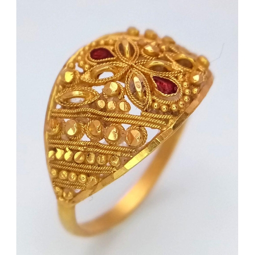 577 - A 21K Yellow Gold, Pierced and Ornate Decorative Indian Ring. Garnet accents. Size N. 2.8g total wei... 