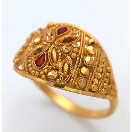 577 - A 21K Yellow Gold, Pierced and Ornate Decorative Indian Ring. Garnet accents. Size N. 2.8g total wei... 