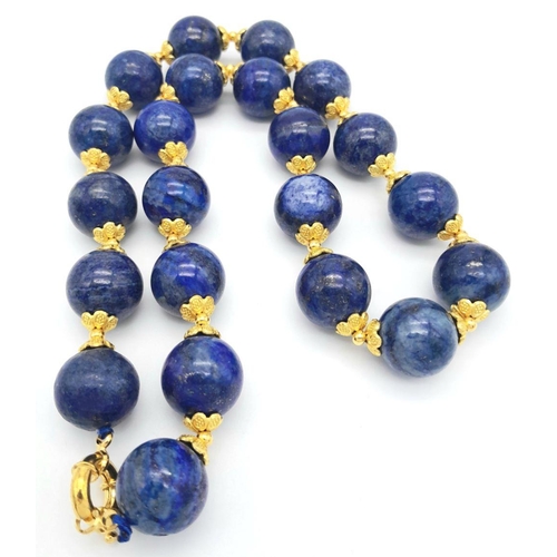 584 - A Large (20mm) Lapis Lazuli Beaded Necklace with Gilded Coronet Spacers and Clasp. 48cm necklace len... 