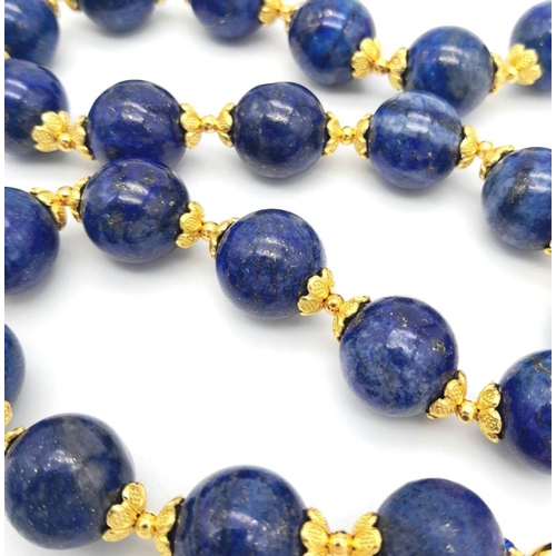 584 - A Large (20mm) Lapis Lazuli Beaded Necklace with Gilded Coronet Spacers and Clasp. 48cm necklace len... 