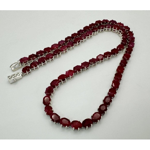 86 - A Ruby Gemstone Tennis Necklace. Oval cuts. Set in 925 silver. 46cm. 40g. CD-1355