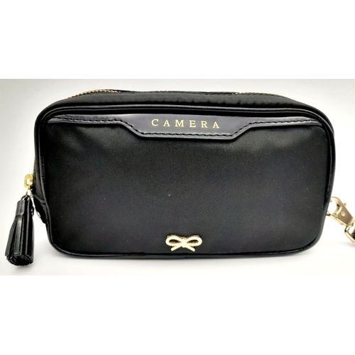 522 - A Black Anya Hindmarch Pouch. Nylon exterior, Capra leather trims, gold-tone hardware and gold-tone ... 