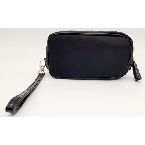 522 - A Black Anya Hindmarch Pouch. Nylon exterior, Capra leather trims, gold-tone hardware and gold-tone ... 