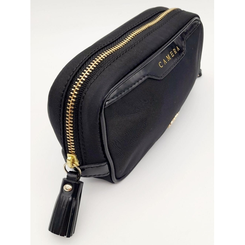 522 - A Black Anya Hindmarch Pouch. Nylon exterior, Capra leather trims, gold-tone hardware and gold-tone ... 