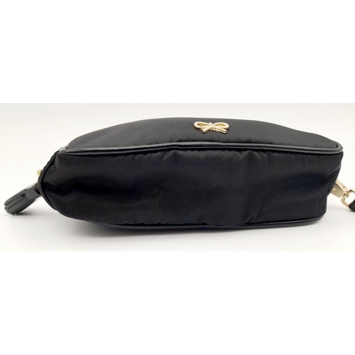 522 - A Black Anya Hindmarch Pouch. Nylon exterior, Capra leather trims, gold-tone hardware and gold-tone ... 