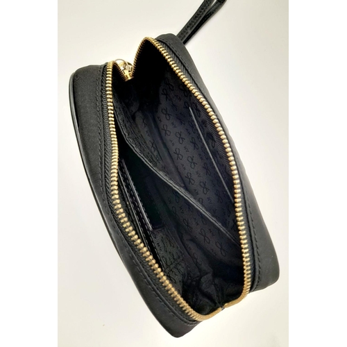 522 - A Black Anya Hindmarch Pouch. Nylon exterior, Capra leather trims, gold-tone hardware and gold-tone ... 