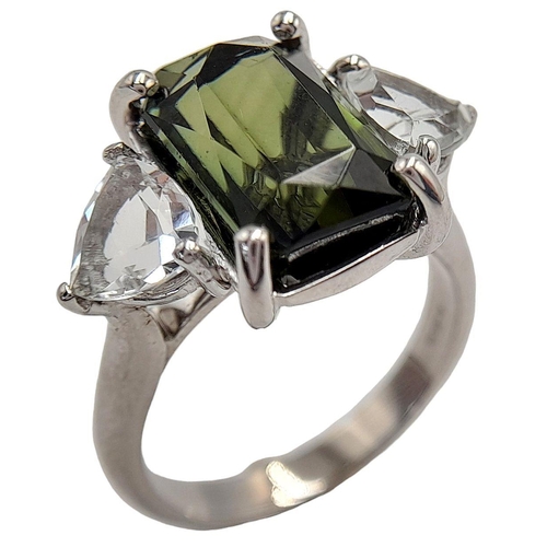 178 - An 18K White Gold Tourmaline and Diamond Ring. A 5ct rectangular rich green tourmaline with a 0.5ct ... 