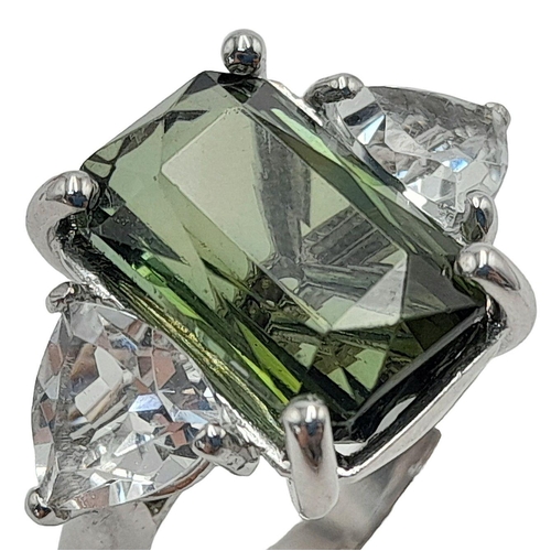 178 - An 18K White Gold Tourmaline and Diamond Ring. A 5ct rectangular rich green tourmaline with a 0.5ct ... 