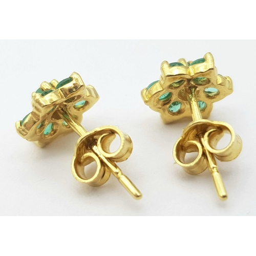 214 - A Pair of 18K Yellow Gold Emerald Stud Earrings. Floral form. 
2g total weight.