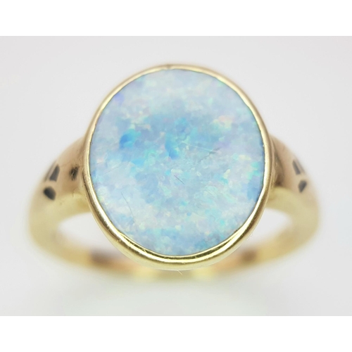 23 - A 14K Yellow Gold Opal Ring. Oval cut opal with good colour play. Size M. 4g total weight.