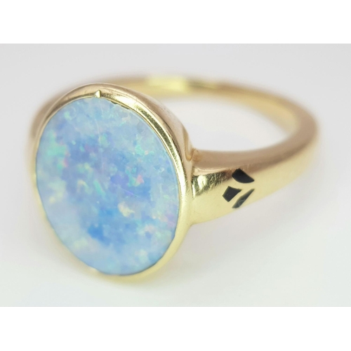 23 - A 14K Yellow Gold Opal Ring. Oval cut opal with good colour play. Size M. 4g total weight.