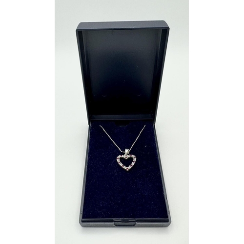 452 - A 9 Carat White Gold Ruby and Diamond Heart Pendant Necklace. 48cm Length Chain. Pendant 1.5cm Wide.... 