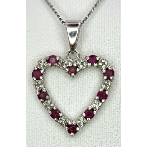 452 - A 9 Carat White Gold Ruby and Diamond Heart Pendant Necklace. 48cm Length Chain. Pendant 1.5cm Wide.... 