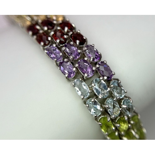 473 - A Sterling Silver Multi Semi Precious Stone Set Bracelet. 19cm Length, 1cm Wide. Set with Oval Cut P... 