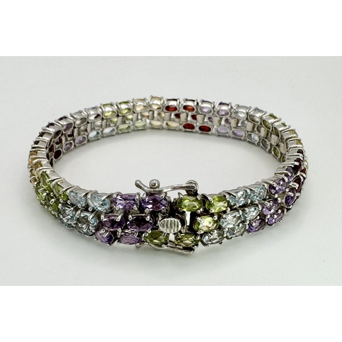 473 - A Sterling Silver Multi Semi Precious Stone Set Bracelet. 19cm Length, 1cm Wide. Set with Oval Cut P... 