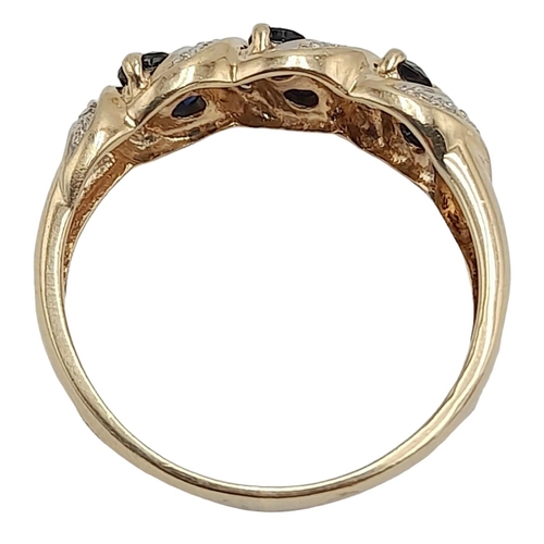 9 - A 9K Yellow Gold, Diamond and Sapphire Crossover Ring. Size O. 2.34g total weight.