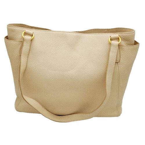 338 - A Prada Cream Leather Tote Bag. Dual flat handles, gold tone hardware. Exterior pocket to each side.... 