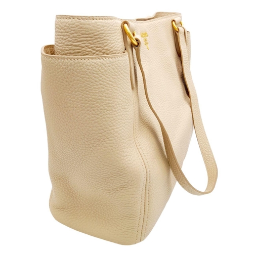 338 - A Prada Cream Leather Tote Bag. Dual flat handles, gold tone hardware. Exterior pocket to each side.... 