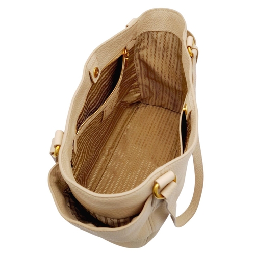 338 - A Prada Cream Leather Tote Bag. Dual flat handles, gold tone hardware. Exterior pocket to each side.... 