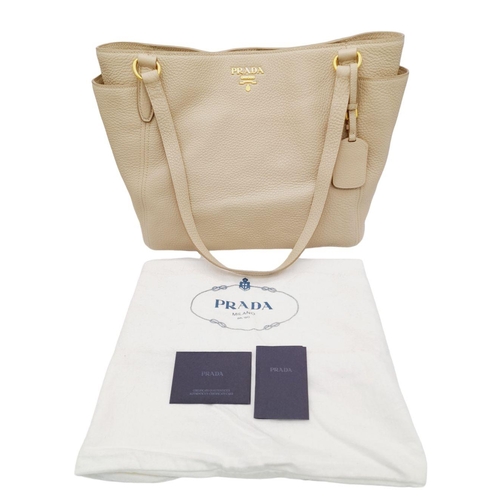 338 - A Prada Cream Leather Tote Bag. Dual flat handles, gold tone hardware. Exterior pocket to each side.... 