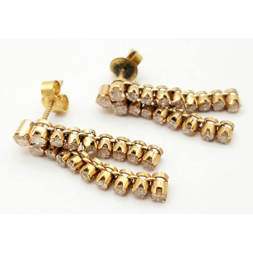 92 - A Pair of 18K Yellow Gold and Diamond Drop Earrings. Eighteen diamonds on each earring. 2.5cm drop. ... 