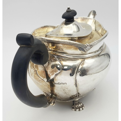 261 - A SOLID SILVER FOOTED TEA POT HALLMARKED SHEFFIELD 1903 .   772gms