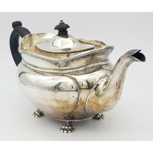 261 - A SOLID SILVER FOOTED TEA POT HALLMARKED SHEFFIELD 1903 .   772gms