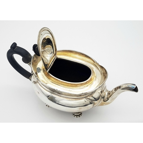 261 - A SOLID SILVER FOOTED TEA POT HALLMARKED SHEFFIELD 1903 .   772gms