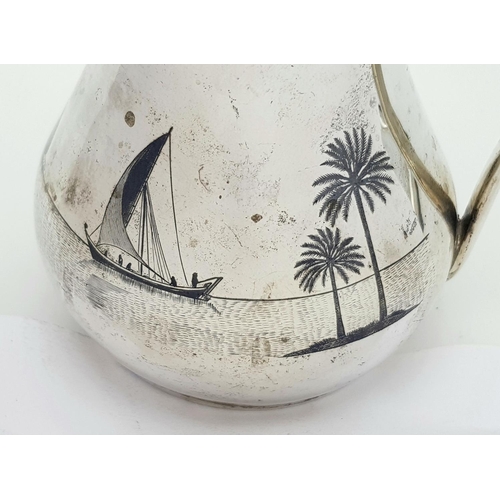 269 - AN EGYPTIAN SILVER JUG WITH ENGRAVEED NILE SCENE .  150gms     11cms TALL