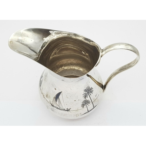 269 - AN EGYPTIAN SILVER JUG WITH ENGRAVEED NILE SCENE .  150gms     11cms TALL