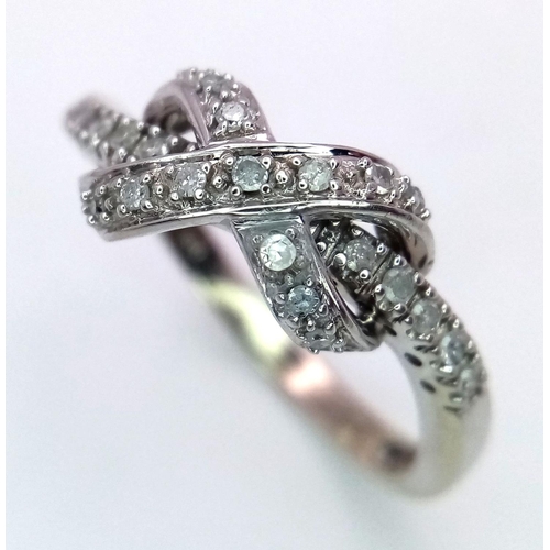 270 - A 9K WHITE GOLD DIAMOND SET BOW CROSSOVER RING 2.8G , SIZE P.

ref: 4957