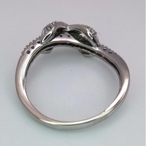 270 - A 9K WHITE GOLD DIAMOND SET BOW CROSSOVER RING 2.8G , SIZE P.

ref: 4957