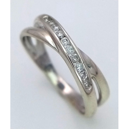 277 - A 9K WHITE GOLD DIAMOND SPLIT CROSSOVER BAND RING 0.15CT , 2.2G , SIZE N.

ref: 5176