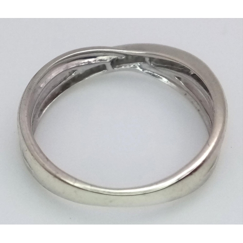 277 - A 9K WHITE GOLD DIAMOND SPLIT CROSSOVER BAND RING 0.15CT , 2.2G , SIZE N.

ref: 5176