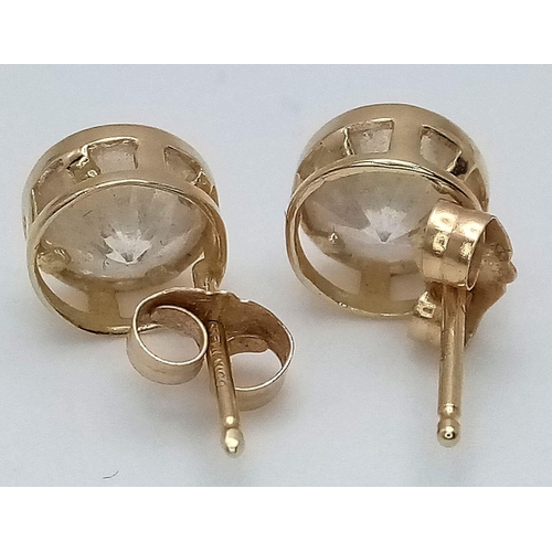 294 - Pair of 14 carat GOLD EARRINGS with round cut ZIRCONIA set in searchlight style. Complete with Gold ... 