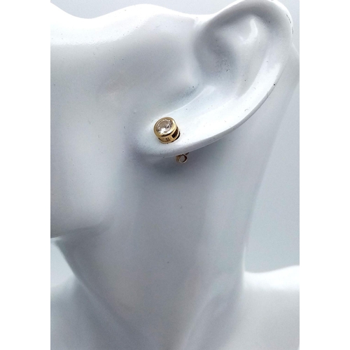 294 - Pair of 14 carat GOLD EARRINGS with round cut ZIRCONIA set in searchlight style. Complete with Gold ... 