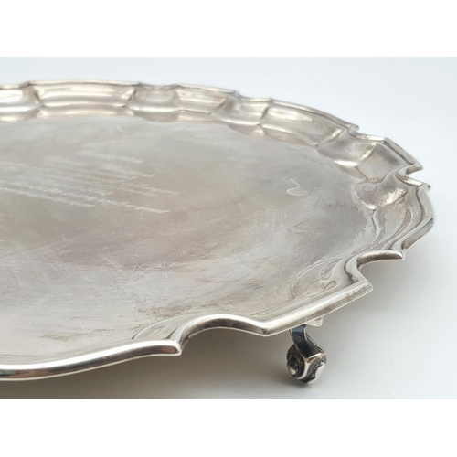 344 - A SOLID SILVER FOOTED PLATTER AWARDED TO A PROMINENT SURGEON ON HIS RETIREMENT IN 2002 .   728.5gms ... 