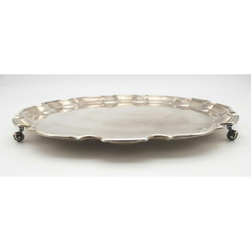 344 - A SOLID SILVER FOOTED PLATTER AWARDED TO A PROMINENT SURGEON ON HIS RETIREMENT IN 2002 .   728.5gms ... 