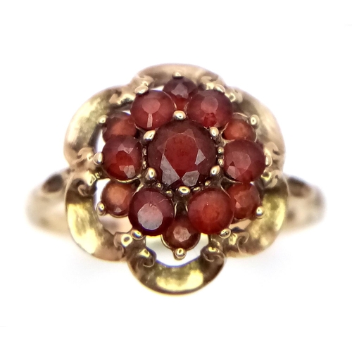 364 - Hallmarked 9 carat GOLD,GARNET CLUSTER RING. Complete with ring box.2.1 grams. Size K.