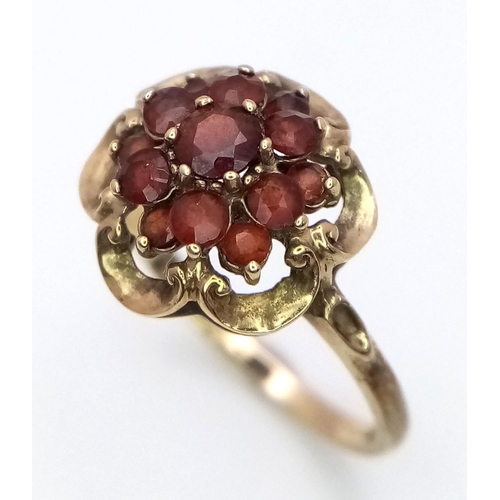 364 - Hallmarked 9 carat GOLD,GARNET CLUSTER RING. Complete with ring box.2.1 grams. Size K.