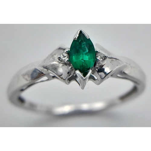 421 - A 10K White Gold Emerald and Diamond Ring. Size N. 1.5g.
017518