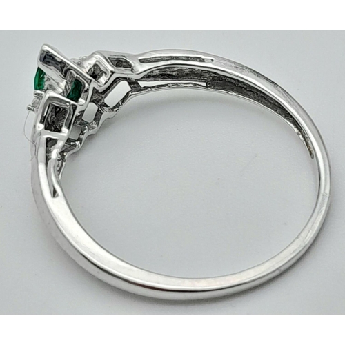 421 - A 10K White Gold Emerald and Diamond Ring. Size N. 1.5g.
017518