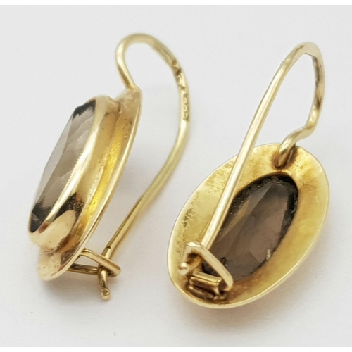 455 - Beautiful pair of 14 carat GOLD,and BROWN AMETHYST EARRINGS. Oval cut in Marquise style. 2.6 grams.