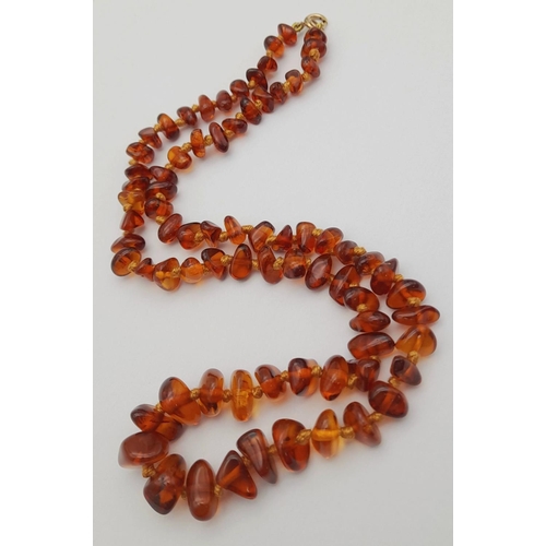 497 - Vintage AMBER NECKLACE with 9 CARAT GOLD CLASP.Consisting various shapes of polished  Amber individu... 